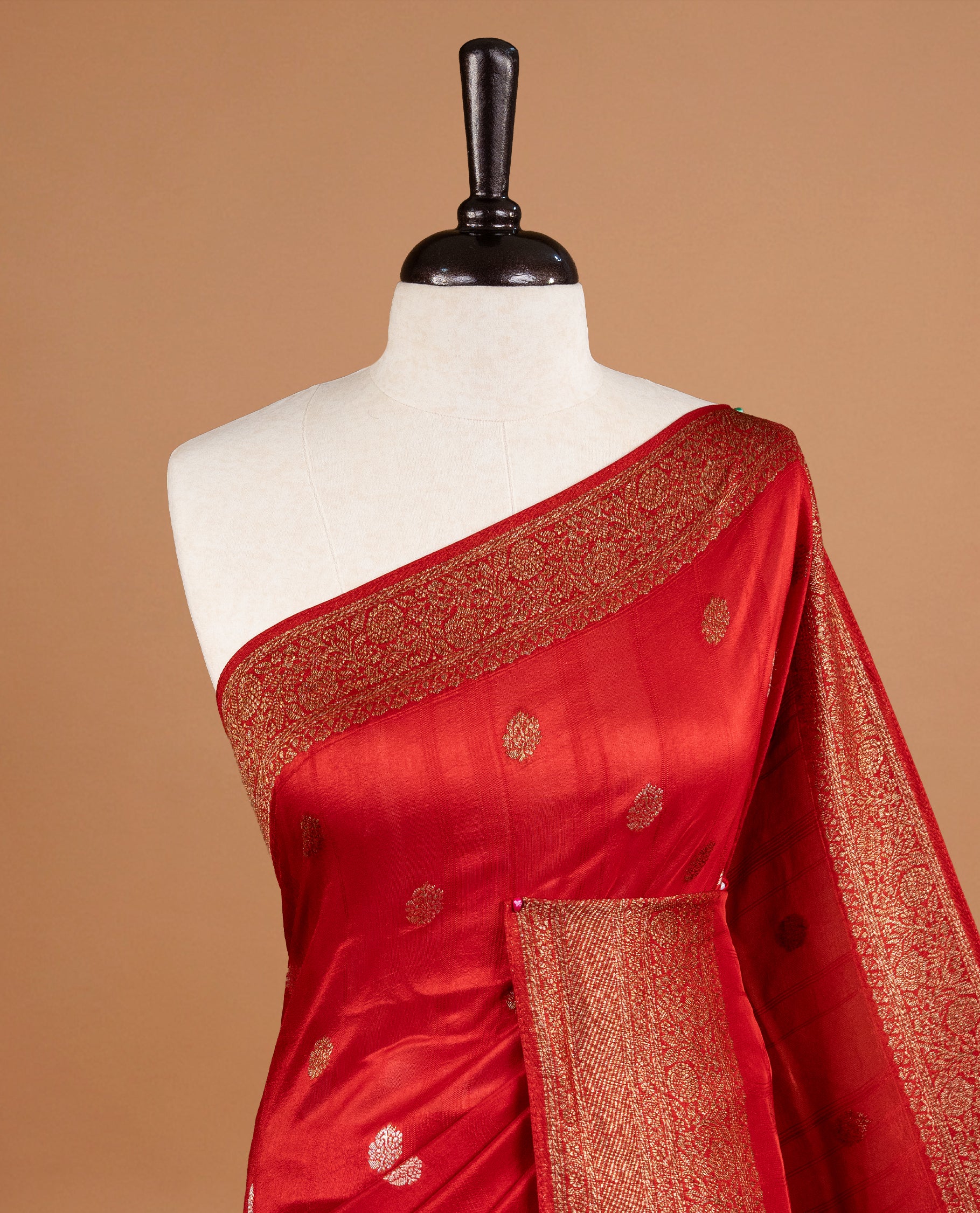 Red colour Semi banaras tussar georgette Saree featuring Antique zari motifs on body, enhanced with antique zari border, paired with a matching blouse piece.