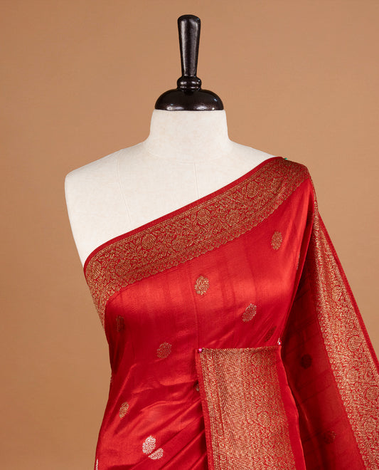Red colour Semi banaras tussar georgette Saree featuring Antique zari motifs on body, enhanced with antique zari border, paired with a matching blouse piece.