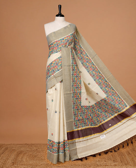 Cream colour Tissue kerala saree featuring Classy Multi colour Box pattern on body, Styled by Burgundy & gold zari border and pallu, comes with matching blouse piece.