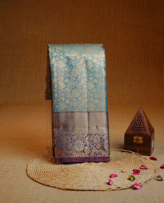 Blue colour Double shade Semi tissue silk saree featuring Gold zari Kodi pattern on body, Contrast Purple colour with traditional border, paired with matching.