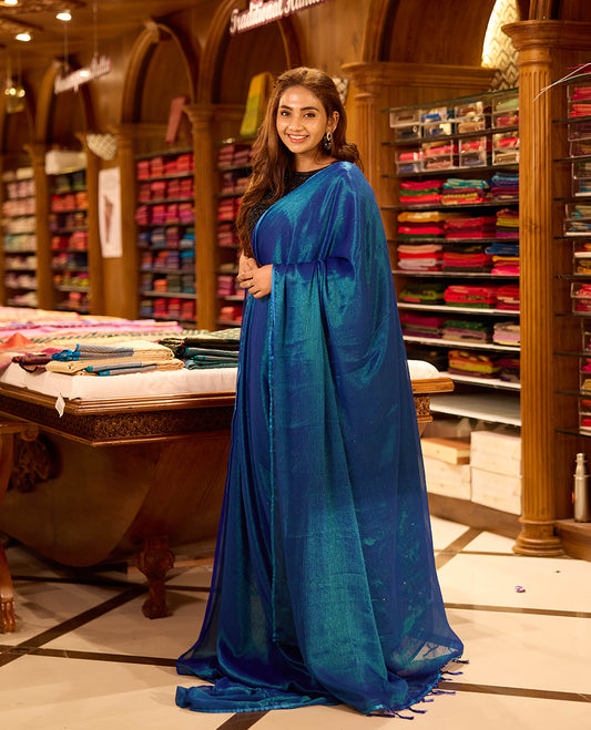 Peacock Blue colour viscose saree in rich teal shade featuring a subtle sheen and lightweight drape, enhanced with satin piping finished border, paired with a matching blouse piece