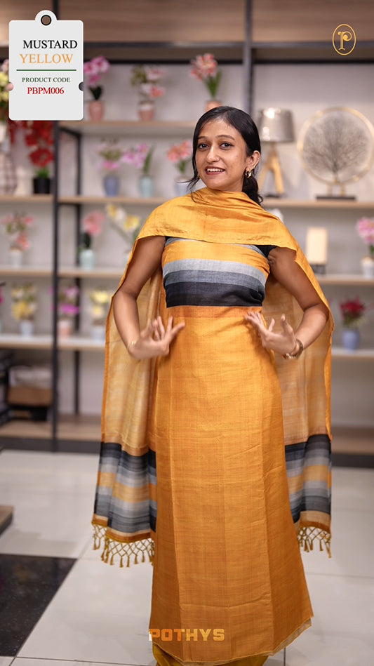 Mustard yellow colour semi tussar silk salwar material featuring elegant horizontal stripes on the yoke and dupatta, woven in shades of black and grey & Paired with a matching plain bottom.