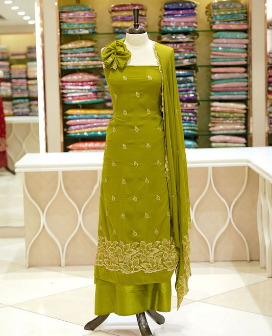 Olive green colour georgette salwar set featuring gold zari buttas on body, floral embroidery and scalp work on dupatta, paired with matching bottom.