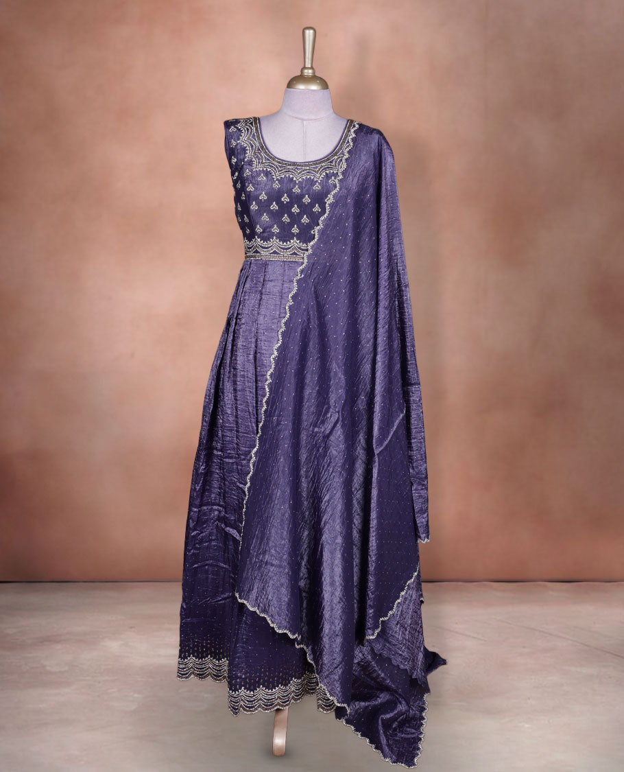 Dark purple colour stitched gown set with sleeveless embroidered yoke, flared ankle‑length silhouette, and attached dupatta featuring dainty butti work and scalloped beaded edging.