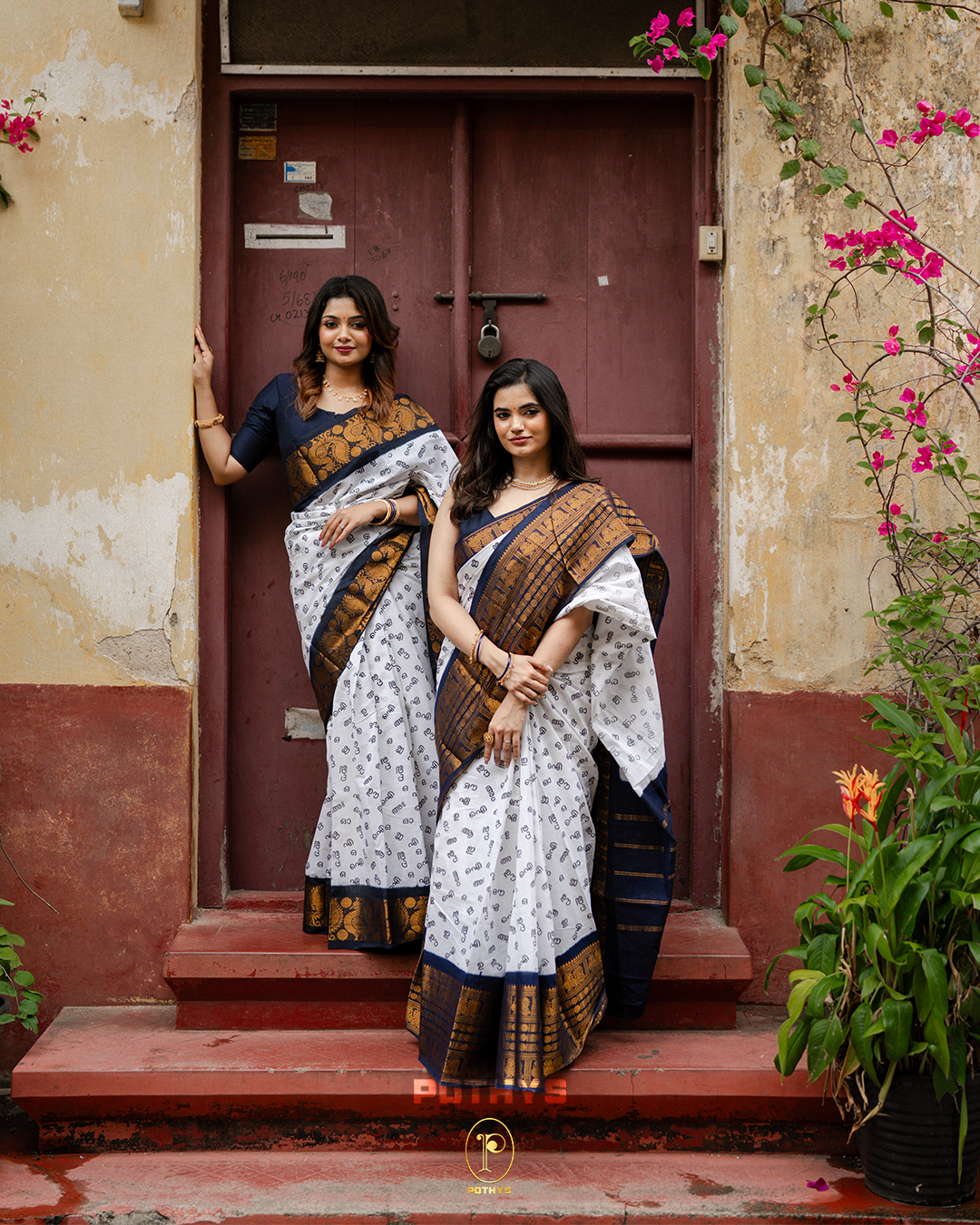 Off White Sungudi Cotton Saree featuring Malayalam alphabets on the body, a navy blue border with gold zari peacock and chakra motifs, a contrast pallu, and a matching blouse piece