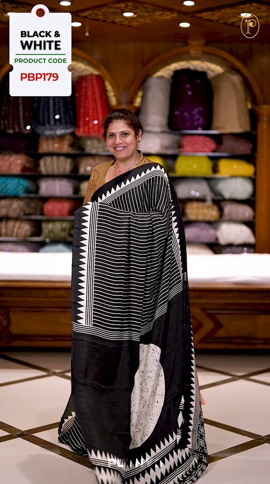 Black semi modal crepe saree featuring white vertical line prints, accented with a temple border and Bold circle Motif design on the pallu, paired with a matching printed blouse