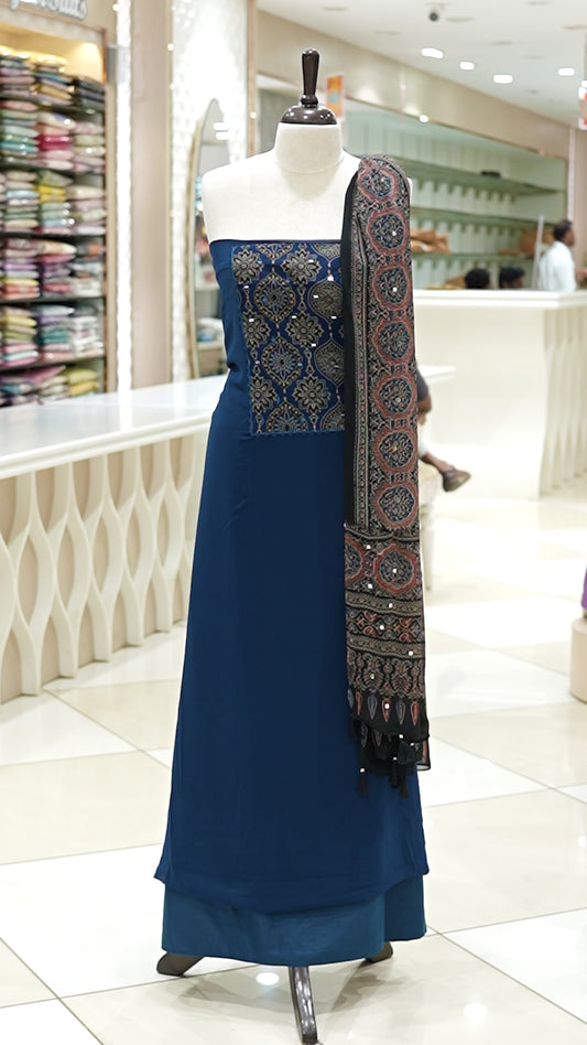 Blue Georgette salwar material featuring Ajrakh print with mirror work on the yoke, paired with Ajrakh printed dupatta with mirror detailing and plain bottom.