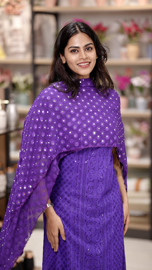 Violet colour Chiffon salwar material featuring elegant chikankari with sequins work on the top, paired with a beautifully mirror worked dupatta and a matching bottom piece for a graceful look.