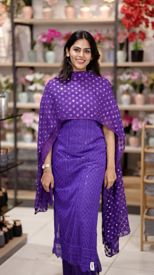 Violet colour Chiffon salwar material featuring elegant chikankari with sequins work on the top, paired with a beautifully mirror worked dupatta and a matching bottom piece for a graceful look.