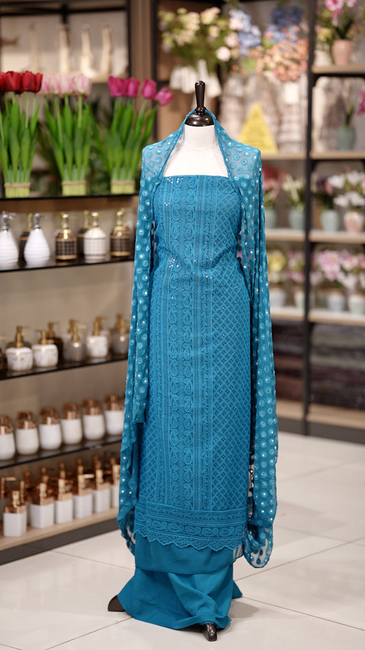 Blue colour Chiffon salwar material featuring elegant chikankari with sequins work on the top, paired with a beautifully mirror worked dupatta and a matching bottom piece for a graceful look.