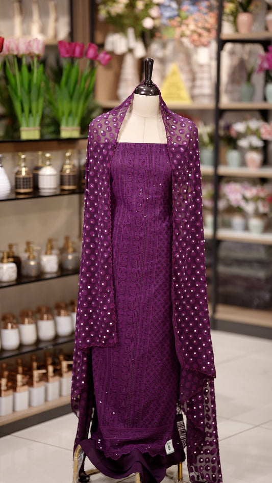 Purple colour Chiffon salwar material featuring elegant chikankari with sequins work on the top, paired with a beautifully mirror worked dupatta and a matching bottom piece for a graceful look.