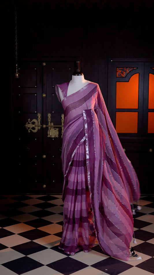 Maroon Mul Mul cotton saree adorned with subtle silver stripes across the body and finished with a delicate silver zari border.