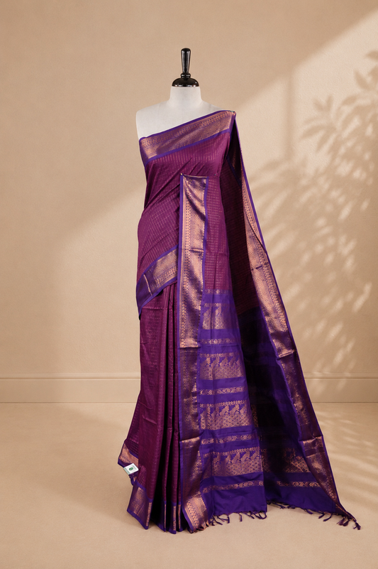 Purple colour kalyani cotton saree featuring gold zari check pattern on body, complemented by Violet colour with Antique zari border, paired with matching blouse piece.