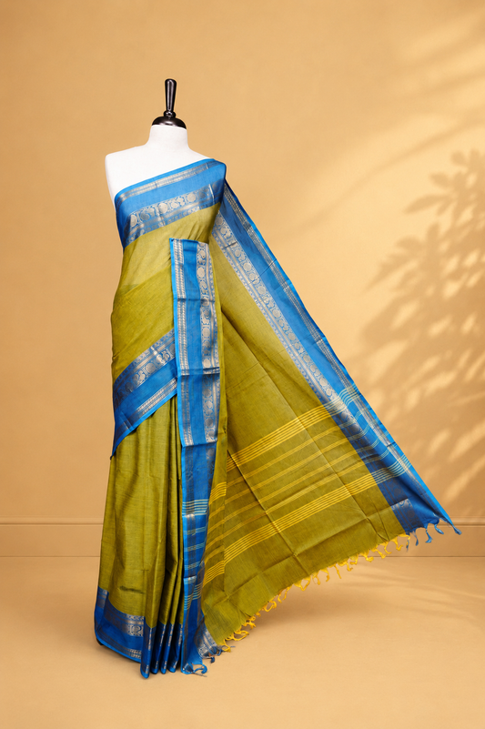 Olive colour Chettinad cotton saree featuring Elegant body, complemented by Contrast Blue colour with Gold zari border, paired with matching blouse piece.