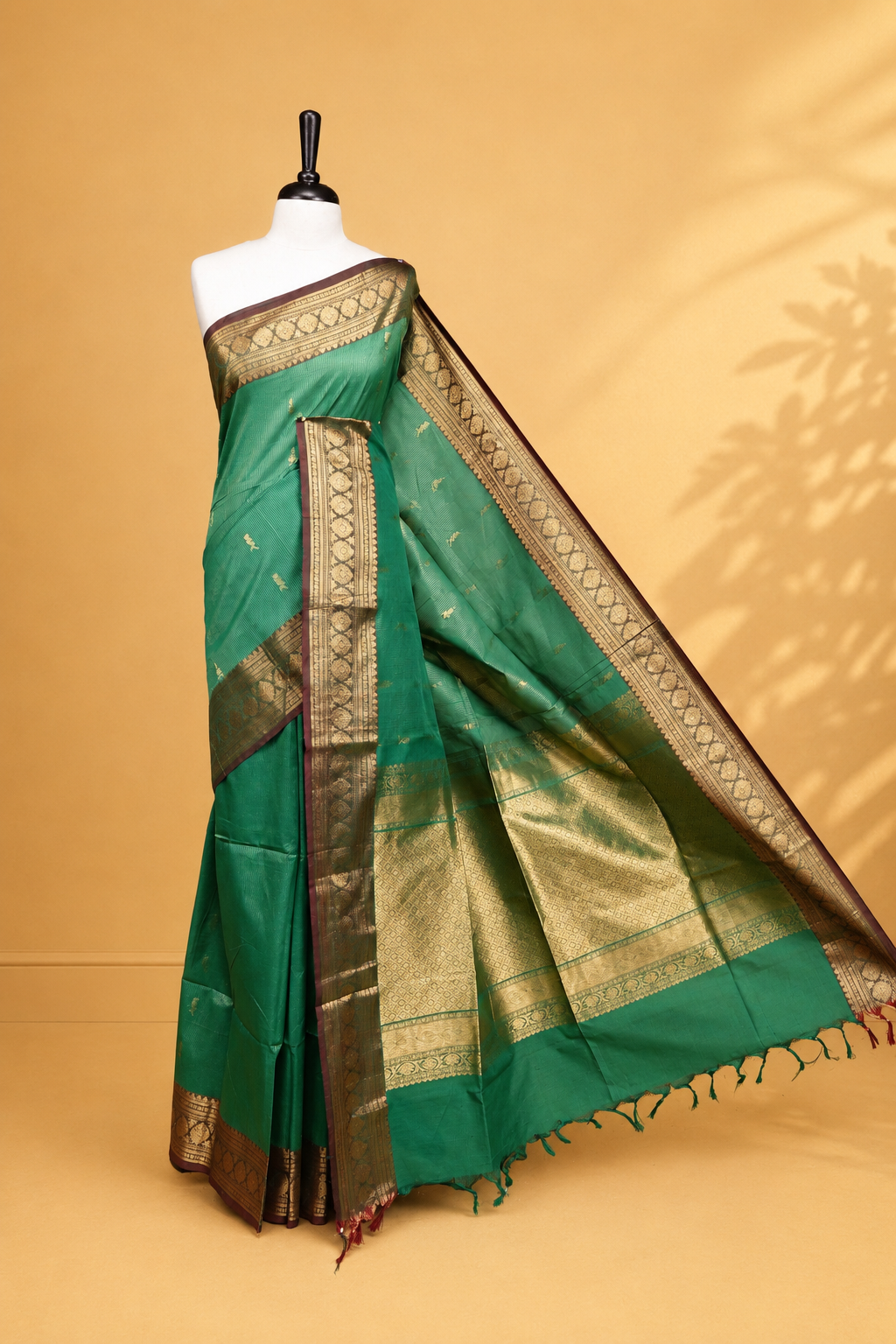 Green colour chettinad cotton saree featuring gold zari stripes & motifs on body, complemented by Contrast Maroon colour with zari border, paired with matching blouse piece.
