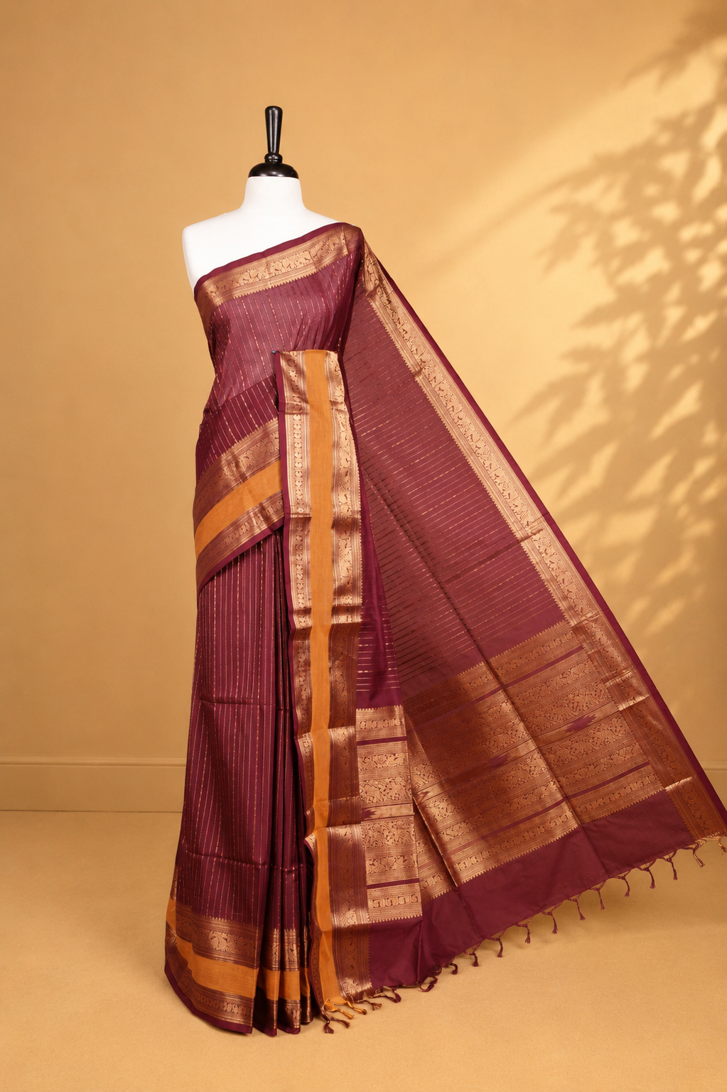 Maroon colour chettinad cotton saree featuring  gold zari stripes on body, complemented by Mustard border, paired with matching blouse piece.