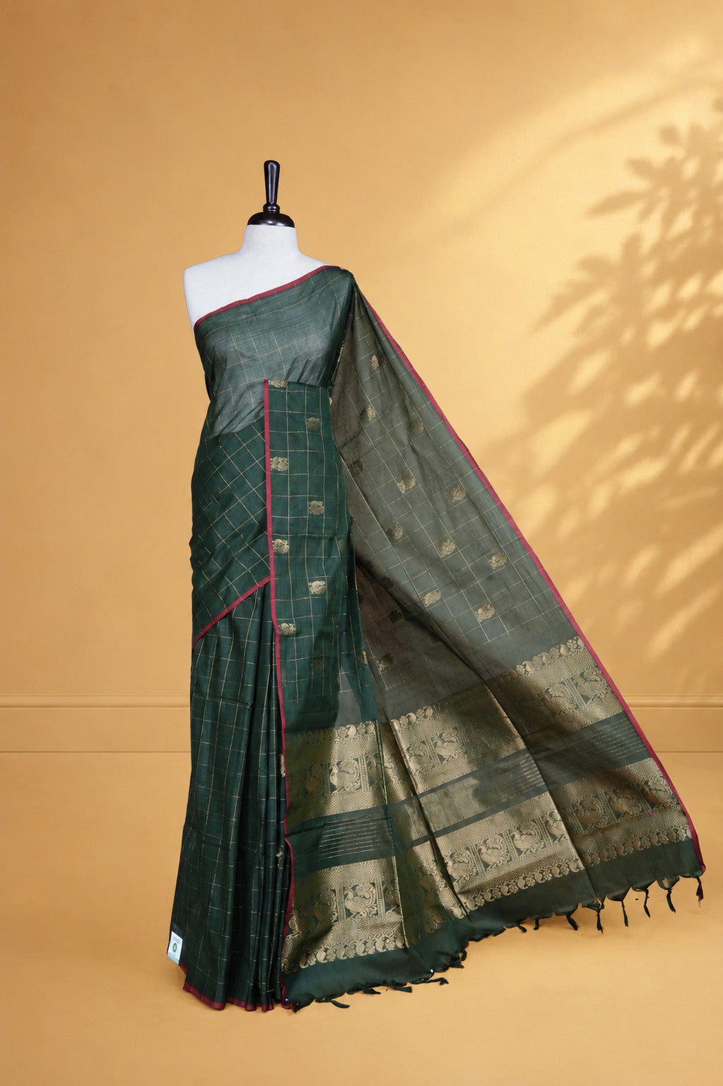 Green colour chettinad cotton saree featuring Gold zari check with Peacock motifs on body, complemented by Red colour piping border, paired with matching blouse.