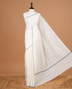 Cream Colour Kerala Saree Featuring A Plain Body, Enhanced By A Minimalistic Green  Border, Paired With A Matching Blouse Piece.
