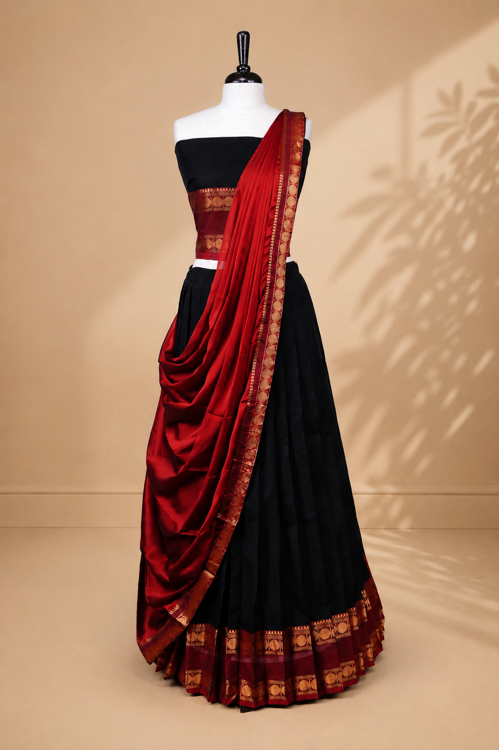 Black colour Half saree featuring Plain skirt with Zari border on contrast Red colour border, Unstitched Blouse and matching dupatta.