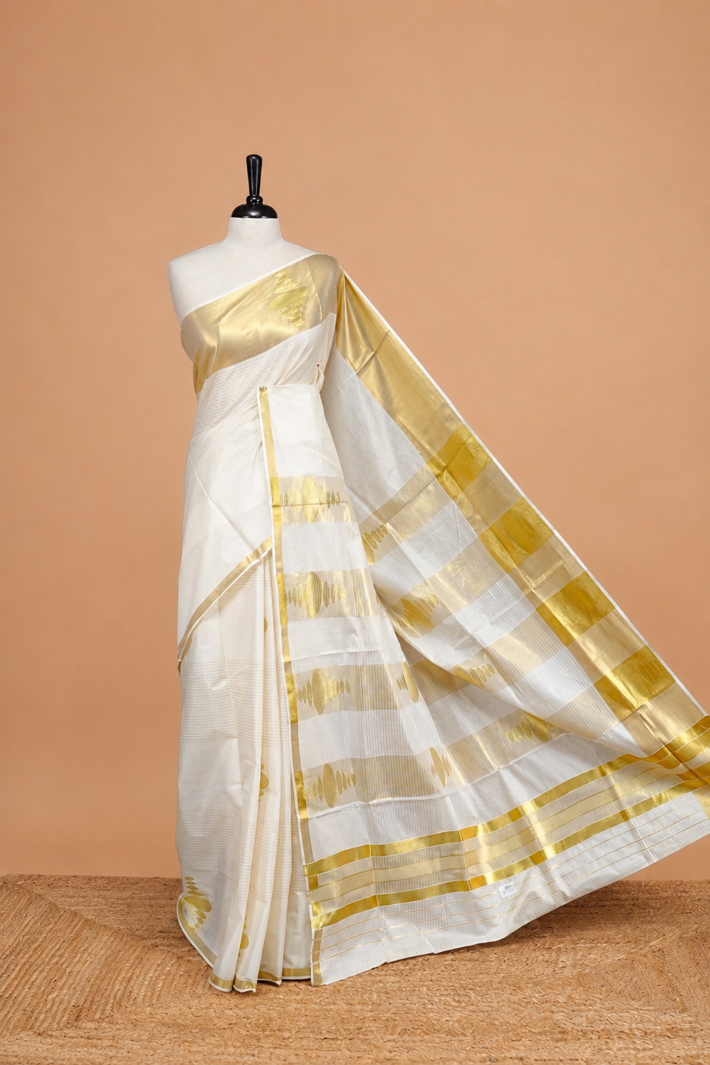 Cream Colour Kerala Saree Featuring Gold Strips  On The Body, Complemented By A  Gold Zari Circle Pattern On Border, Paired With A Matching Blouse Piece.