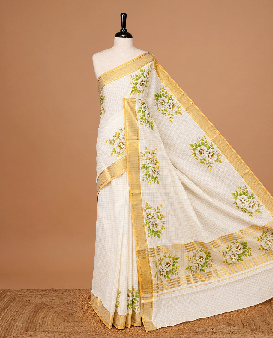 Cream Colour Kerala Saree Featuring Golden Checks On The Body, Complemented By A Traditional  Gold  Zari & Floral Printed Border, Paired  With A Matching Blouse Piece.