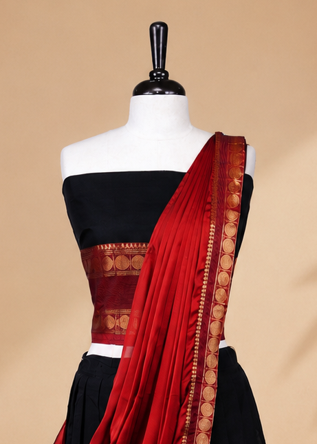 Black colour Half saree featuring Plain skirt with Zari border on contrast Red colour border, Unstitched Blouse and matching dupatta.