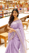 Lavender colour linen tissue saree featuring Floral design with Aari work & contrast simple border, comes with matching blouse piece.