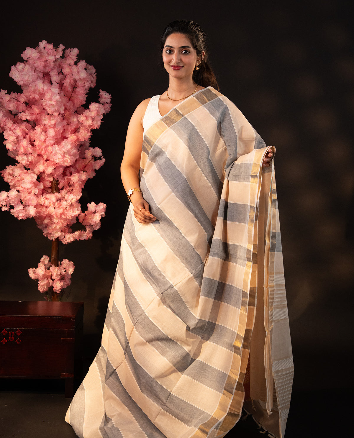 Beige & Grey dual colour Poly cotton saree featuring Stripped design body, complemented by kasavu border and pallu Finished with elegant tassels, comes with matching blouse piece.