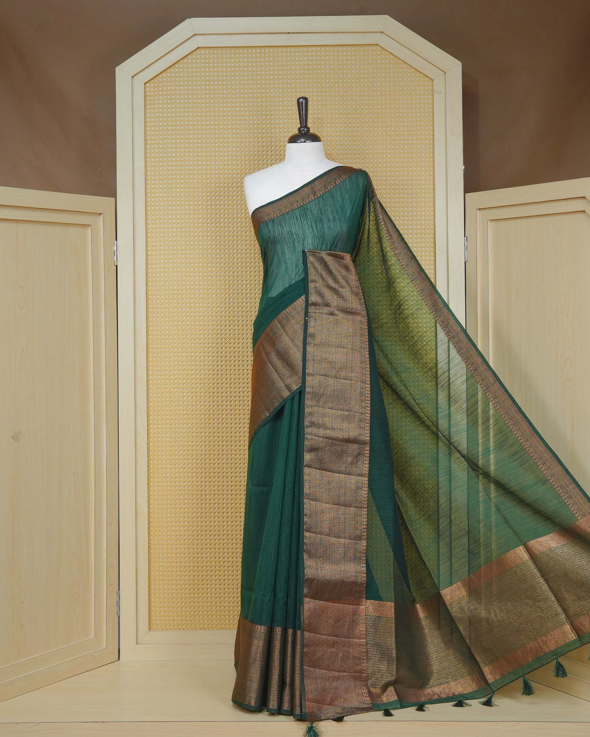 Dark green colour semi linen saree plain body, contrast self colour gold zari detailed border, grand pallu comes with matching blouse piece