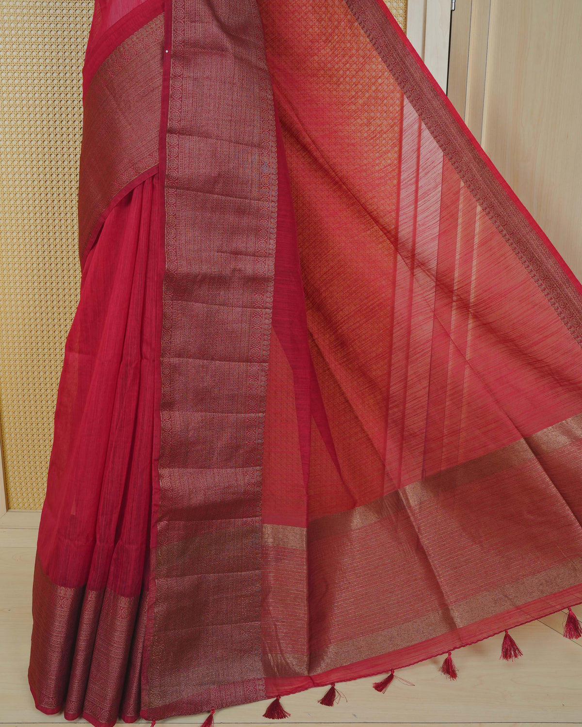 Deep red colour semi linen saree plain body, contrast self colour gold zari detailed border, grand pallu comes with matching blouse piece