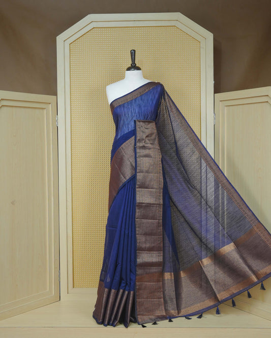 Dark navy blue colour semi linen saree plain body, contrast self colour gold zari detailed border, grand pallu comes with matching blouse piece