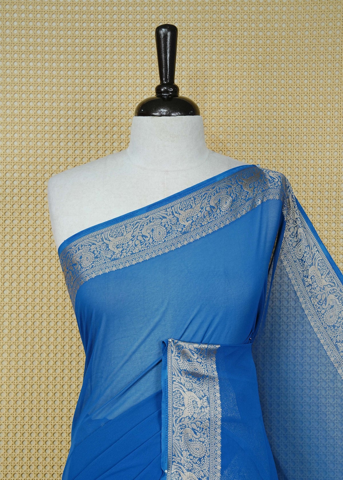Royal blue colour georgette saree having plain body, peacock & deer gold zari detailed border, comes with matching blouse piece