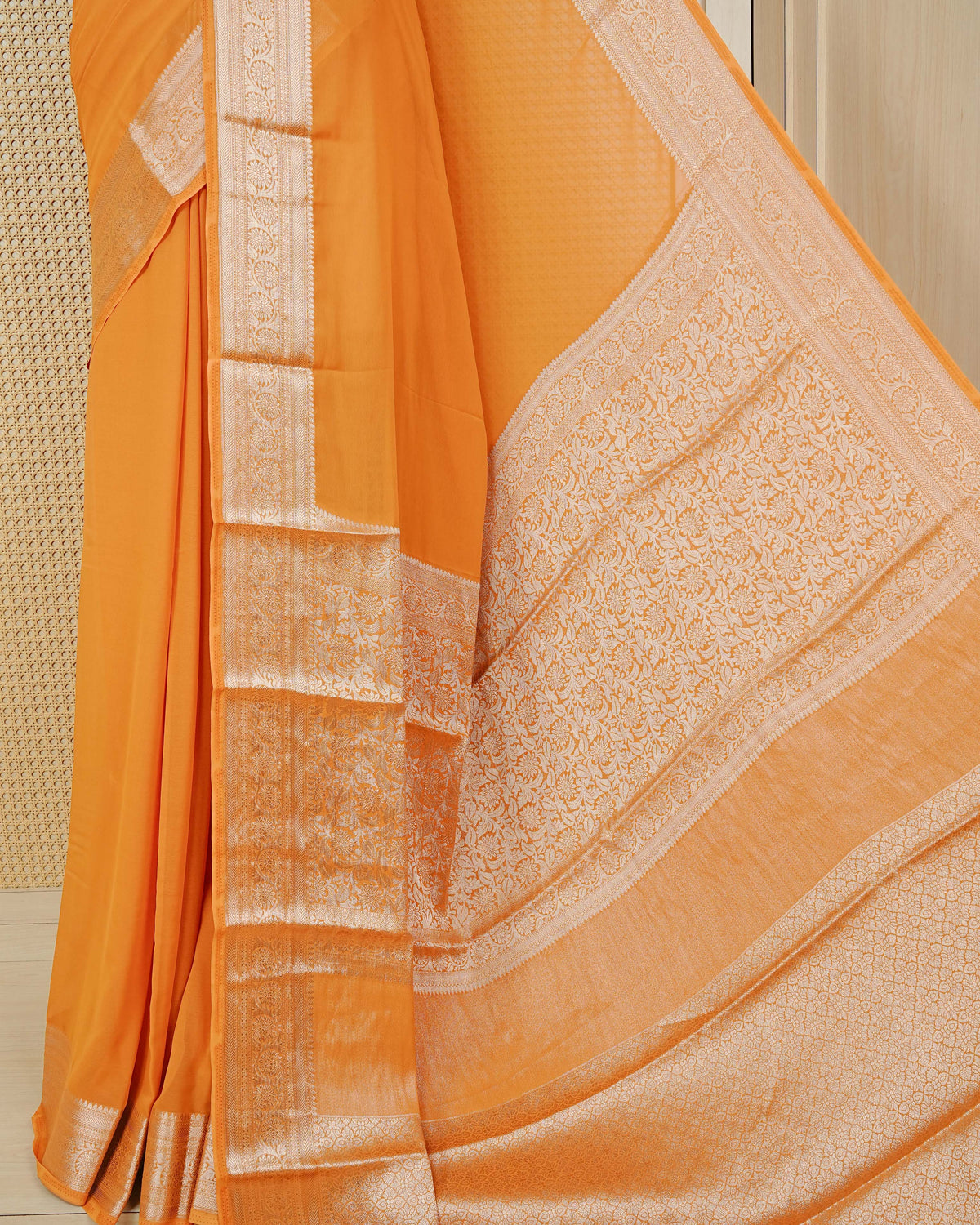 Orange colour georgette saree having plain boy, Floral Gold zari detailed pattern border, comes with matching blouse piece