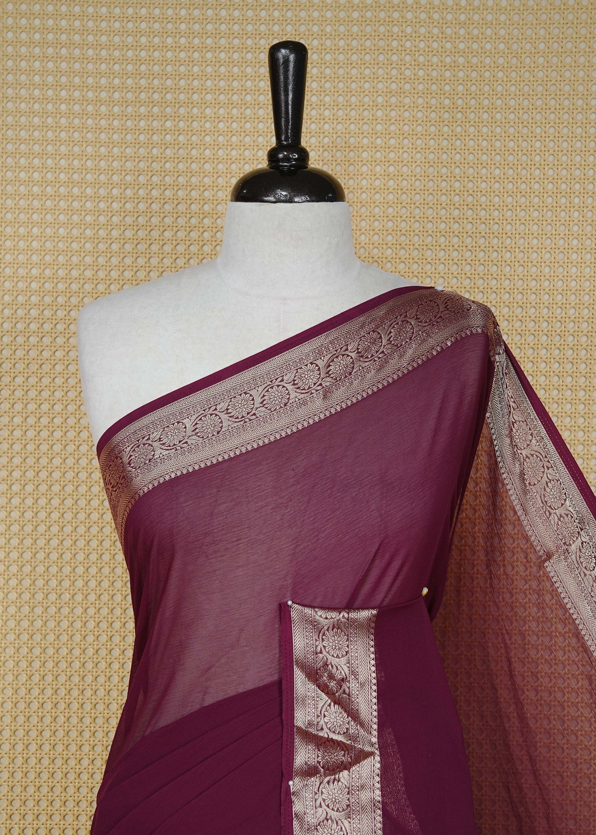 Wine colour georgette saree having plain boy, Floral Gold zari detailed pattern border, comes with matching blouse piece