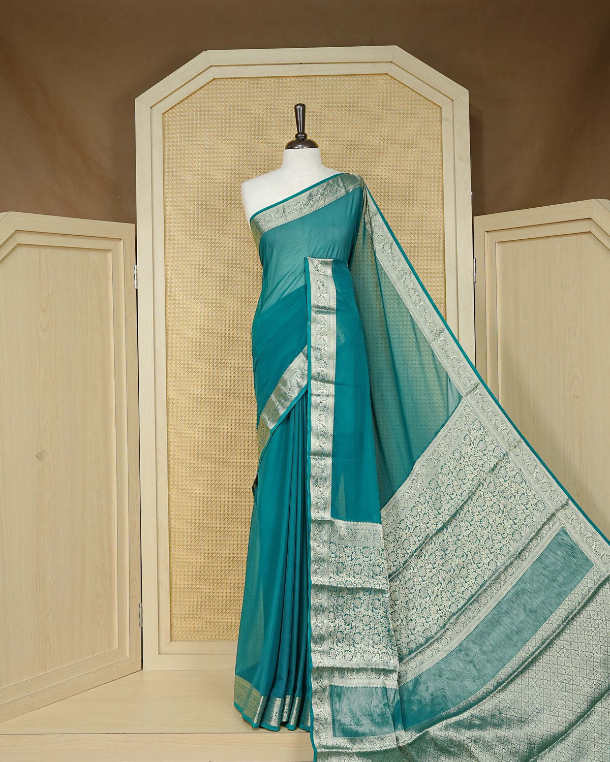 Teal green colour georgette saree having plain boy, Floral Gold zari detailed pattern border, comes with matching blouse piece