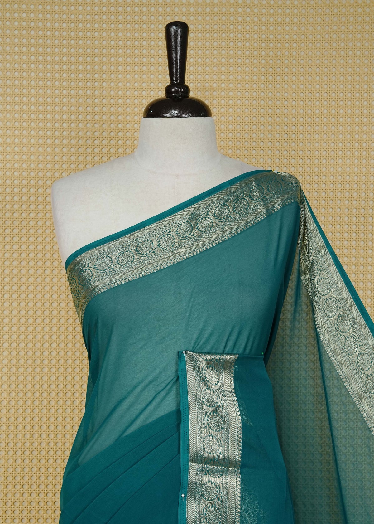 Teal green colour georgette saree having plain boy, Floral Gold zari detailed pattern border, comes with matching blouse piece