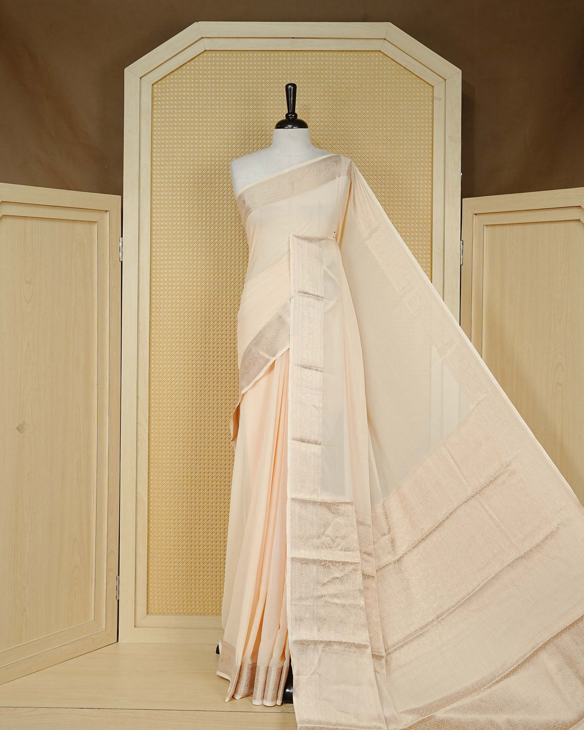 Cream colour georgette saree having plain boy, Floral Gold zari detailed pattern border, comes with matching blouse piece