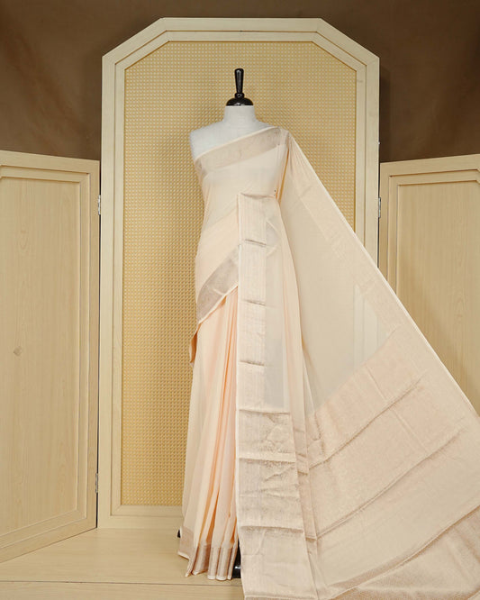Cream colour georgette saree having plain boy, Floral Gold zari detailed pattern border, comes with matching blouse piece