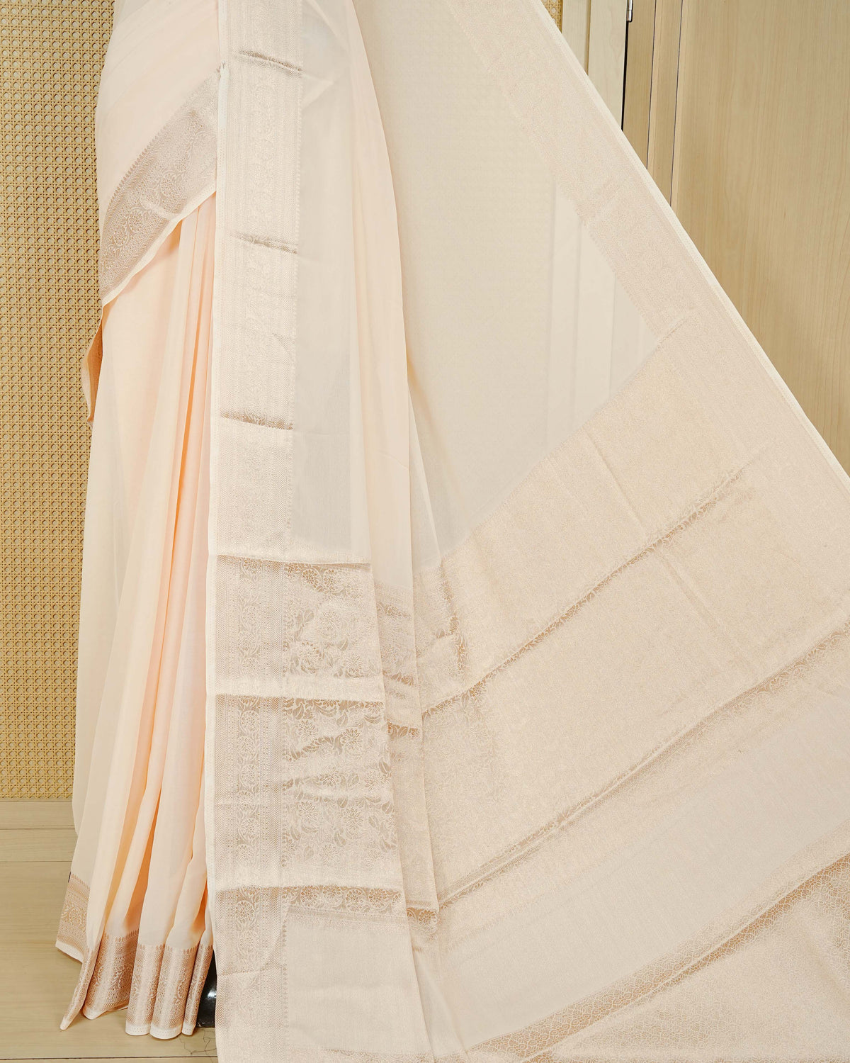 Cream colour georgette saree having plain boy, Floral Gold zari detailed pattern border, comes with matching blouse piece