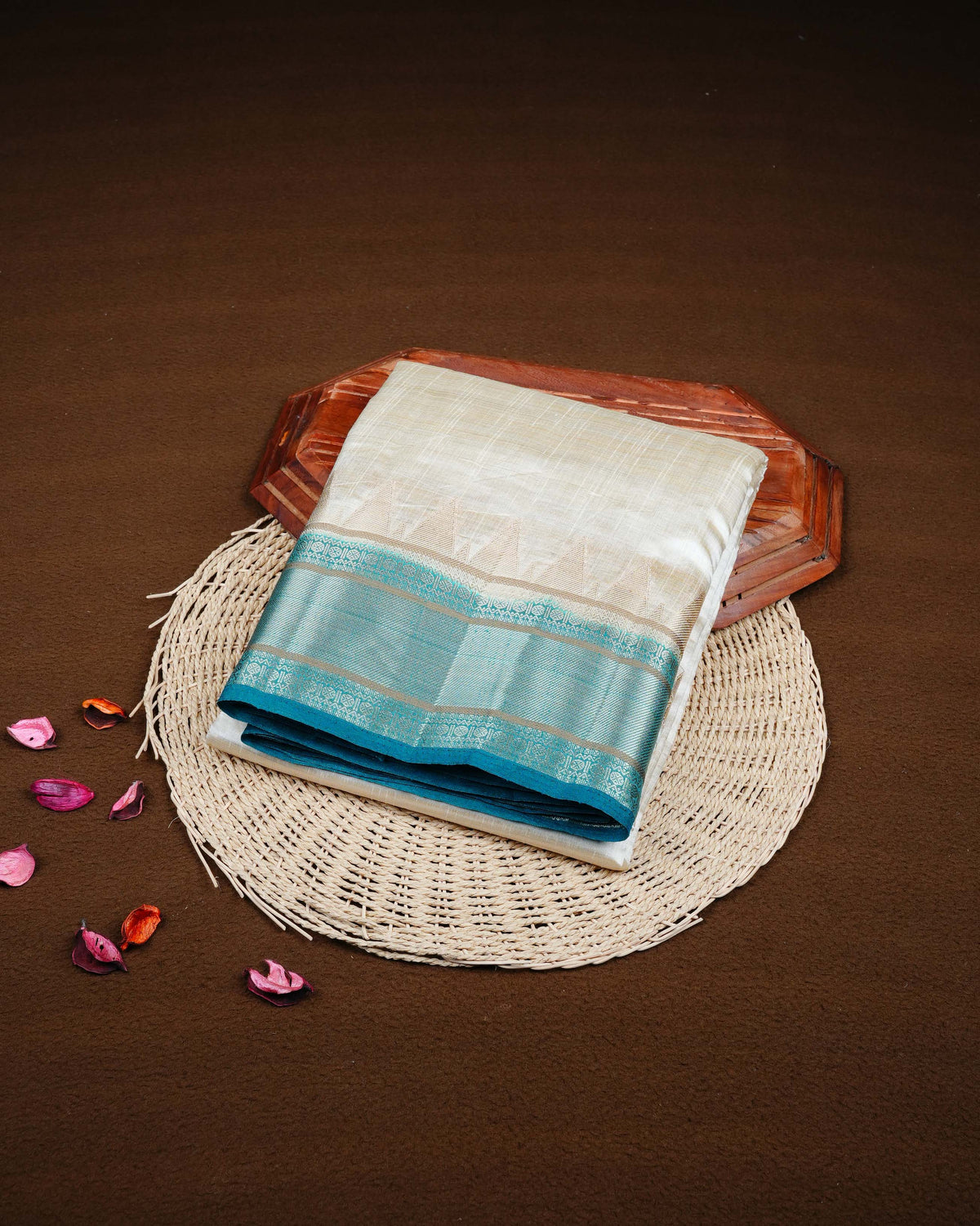 Cream colour Tussar silk saree Featuring Plain body, complemented by Contrast teal green colour gold zari temple & zari border, paired with matching blouse piece.