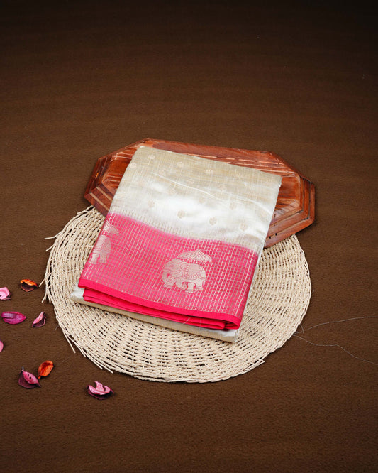 Cream colour Tussar silk saree Featuring buttas on body, complemented by Contrast pink colour gold zari check pattern with elephant motifs on border, paired with matching blouse piece.