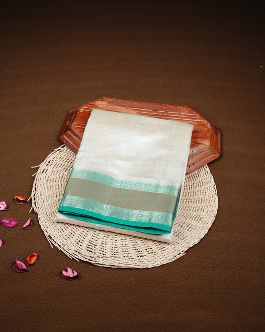 Cream colour Tussar silk saree Featuring Plain body, complemented by Contrast green colour double border with zari detailing, paired with matching blouse piece.