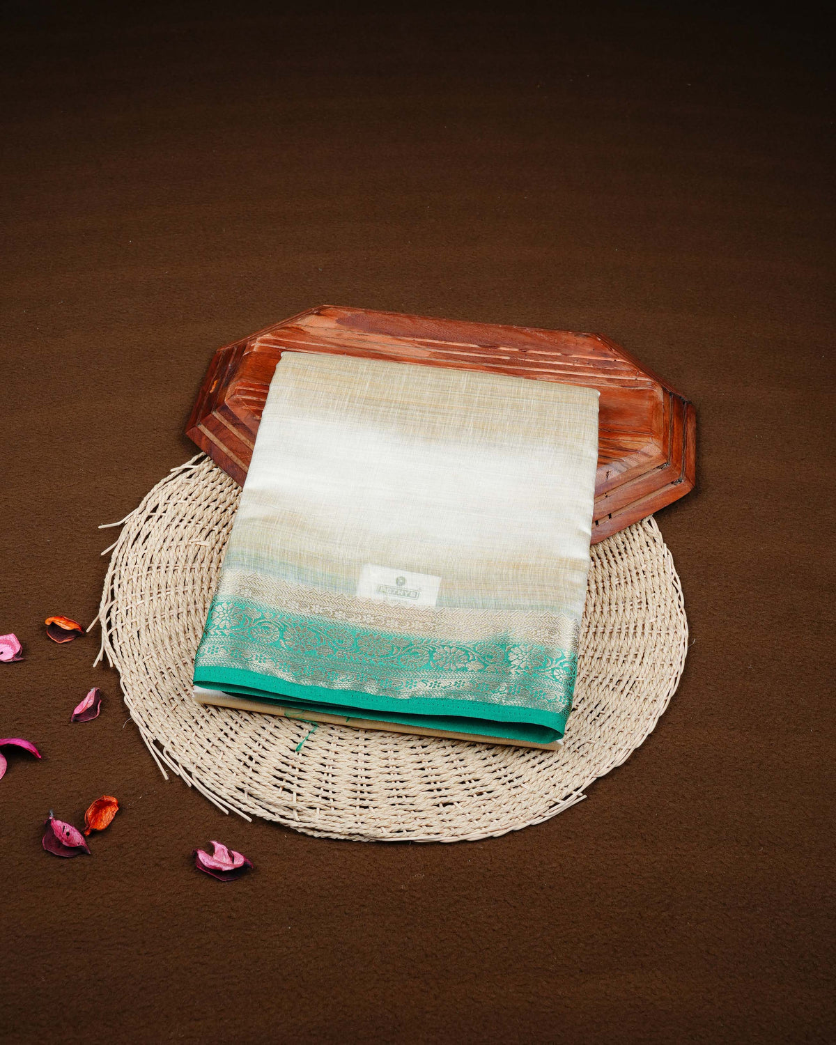 Cream colour Tussar silk saree Featuring Plain body, complemented by Contrast green colour gold zari floral patterns on border, paired with matching blouse piece.
