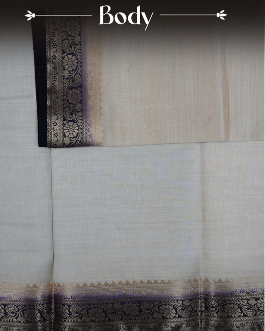 Cream colour Tussar silk saree Featuring Plain body, complemented by Contrast purple colour gold zari floral patterns on border, paired with matching blouse piece.