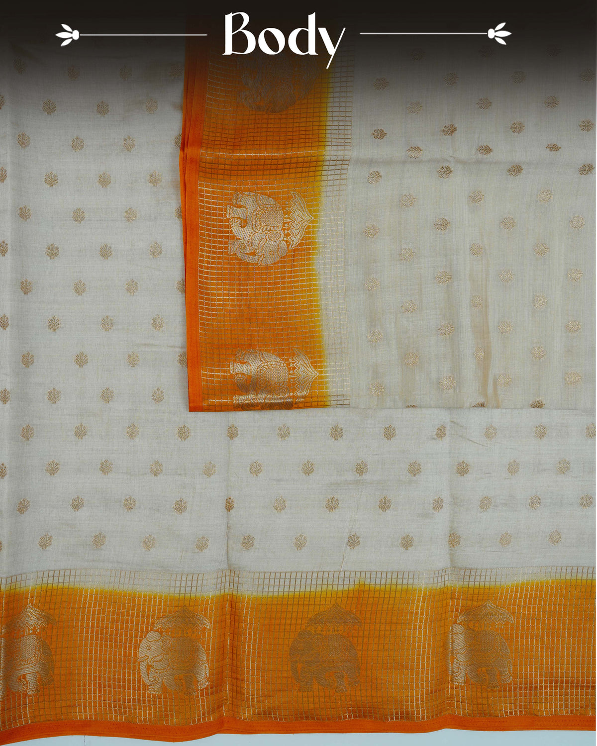 Cream colour Tussar silk saree Featuring buttas on body, complemented by Contrast mustard yellow colour gold zari check pattern with elephant motifs on border, paired with matching blouse piece.