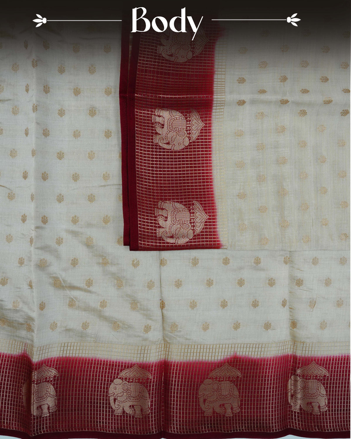 Cream colour Tussar silk saree Featuring buttas on body, complemented by Contrast maroon colour gold zari check pattern with elephant motifs on border, paired with matching blouse piece.