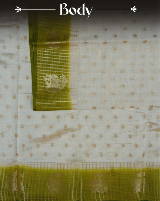Cream colour Tussar silk saree Featuring buttas on body, complemented by Contrast olive green colour gold zari check pattern with elephant motifs on border, paired with matching blouse piece.