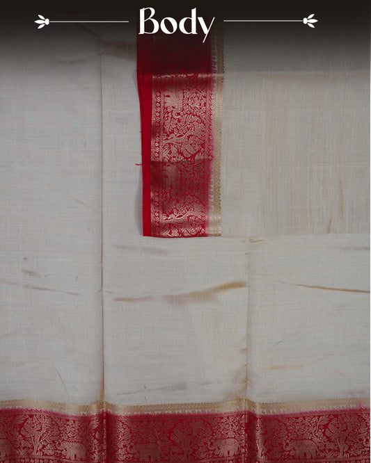 Cream colour Tussar silk saree Featuring Plain body, complemented by Contrast red colour gold zari elephant & tree motifs on border, paired with matching blouse piece.