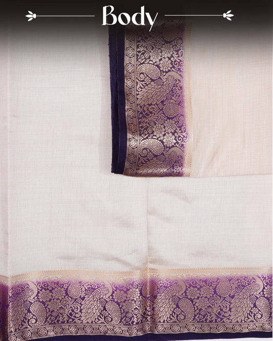 Cream colour Tussar silk saree Featuring Plain body, complemented by Contrast purple colour with gold zari peacock & mango motifs on border, paired with matching blouse piece.