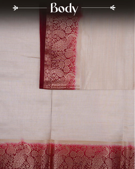 Cream colour Tussar silk saree Featuring Plain body, complemented by Contrast dark maroon colour gold zari peacock & mango motifs on border, paired with matching blouse piece.